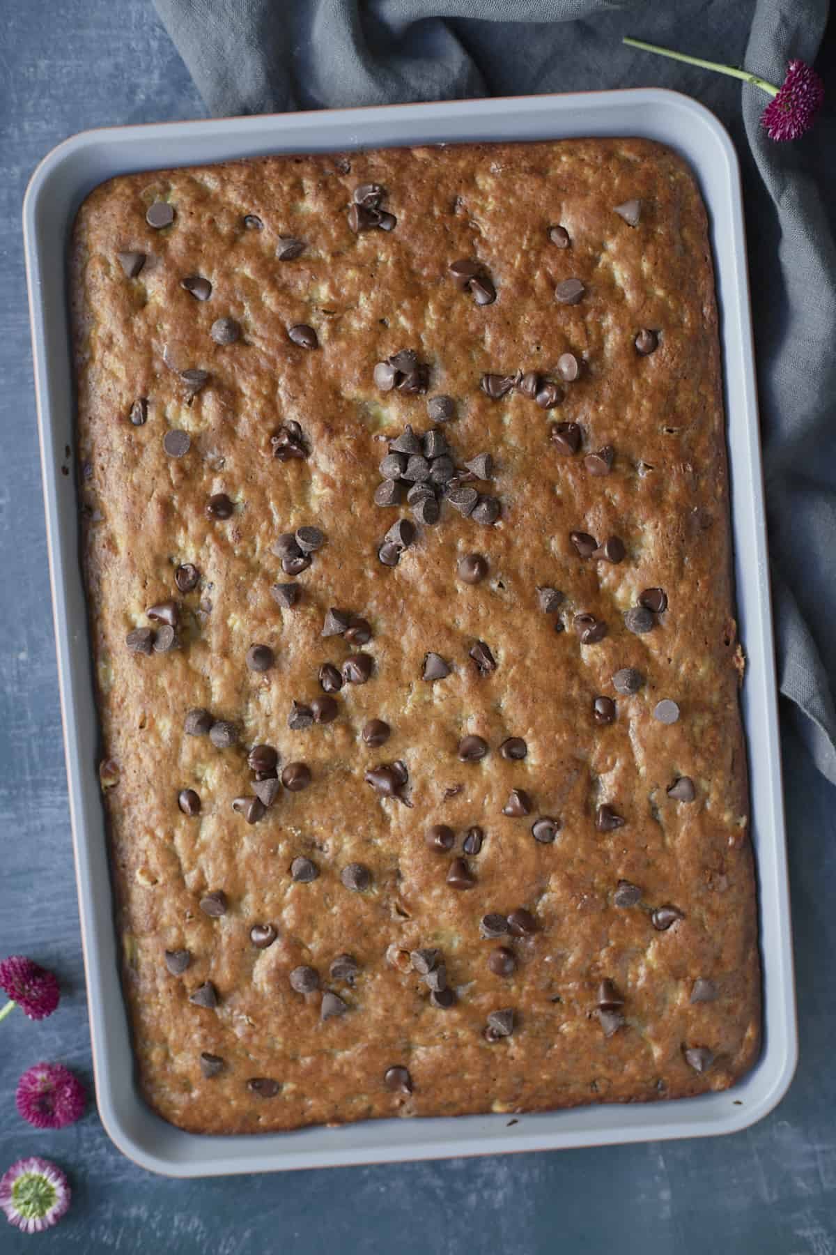 banana bread in a sheet pan topped with chocolate chips