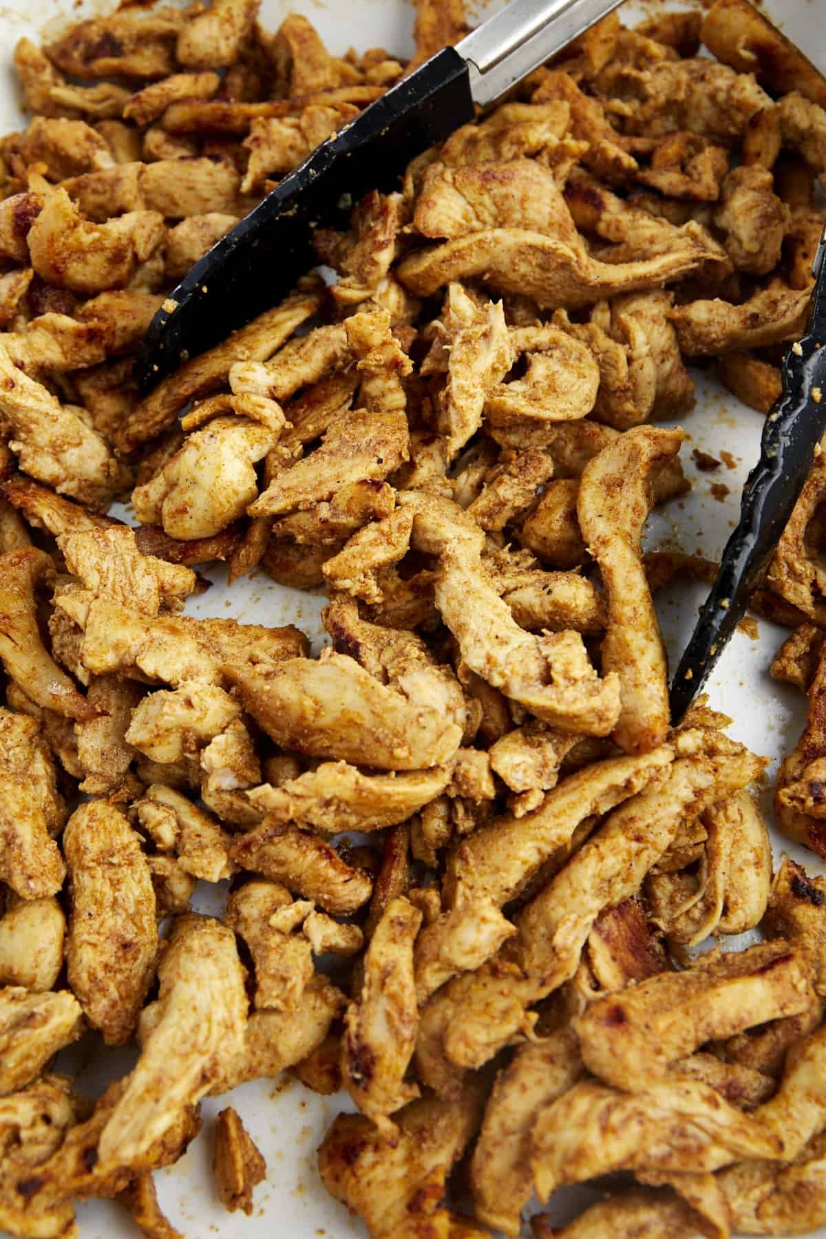 cooked shawarma chicken pieces on a baking sheet