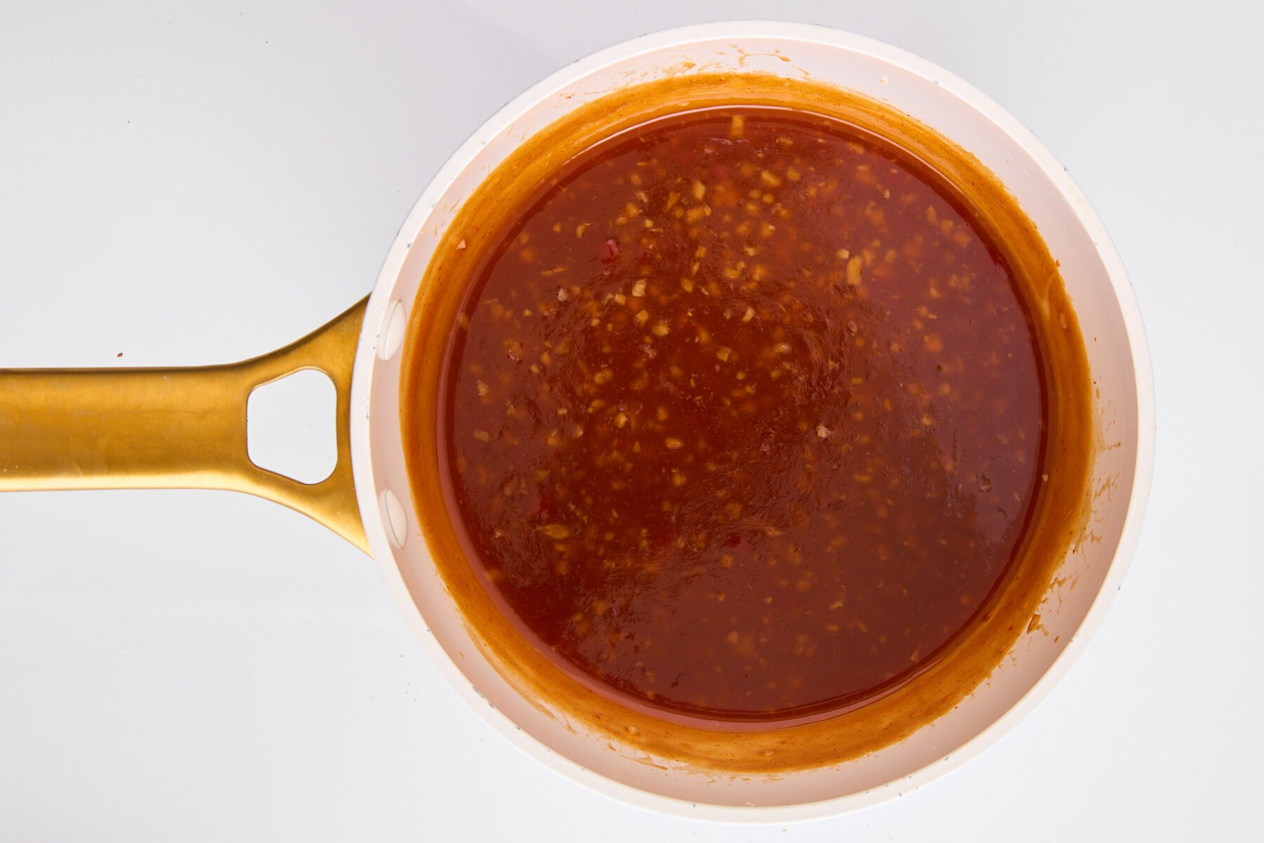 A pot of orange chicken sauce.