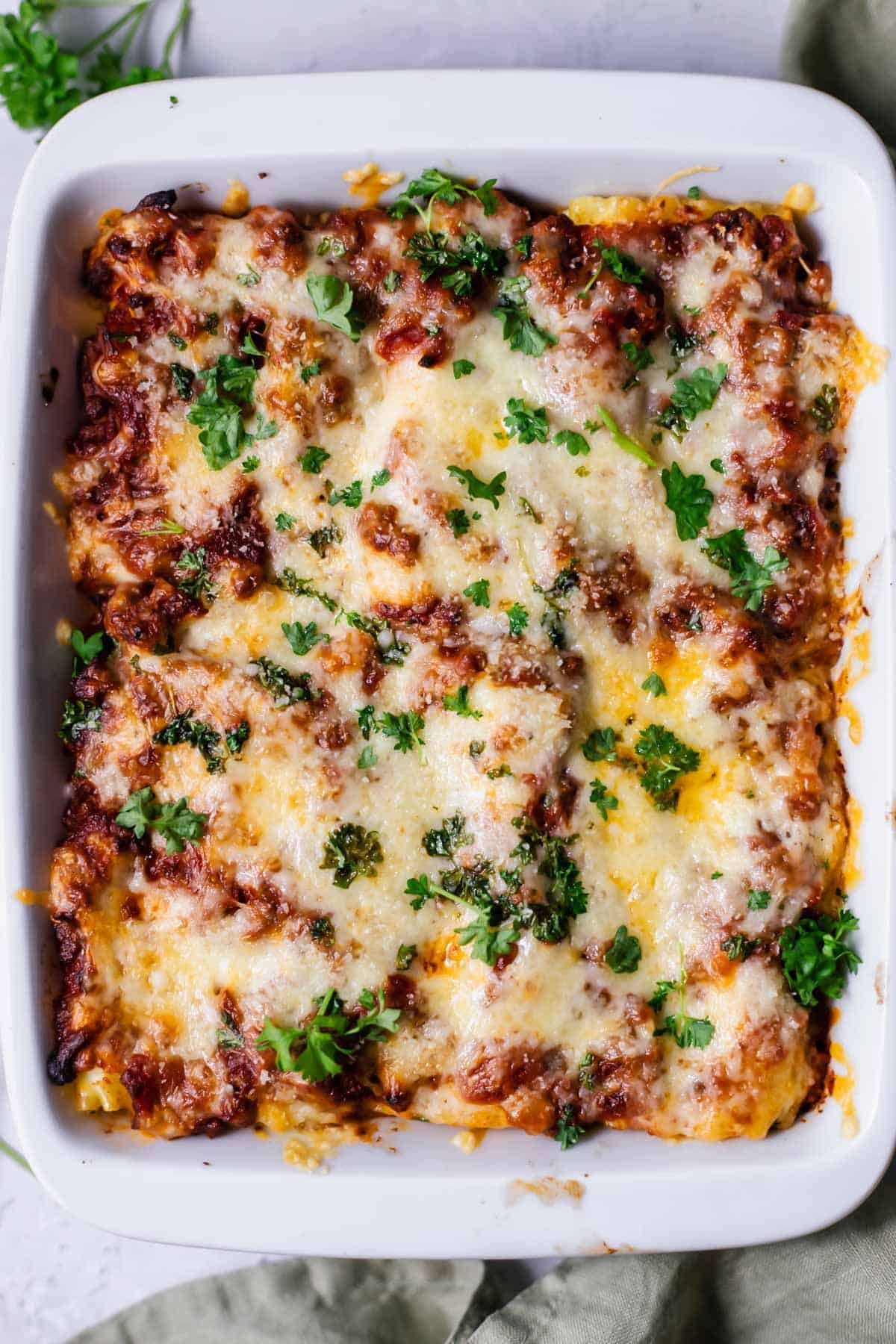 overhead image of a baking dish full of baked lasagna rolls