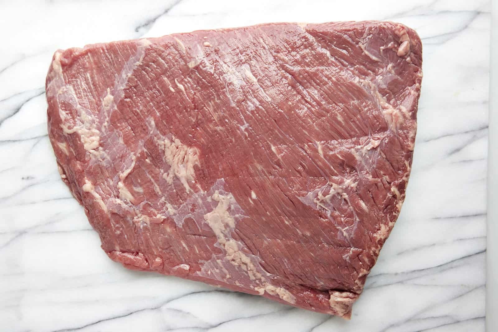 A raw slab of beef brisket.