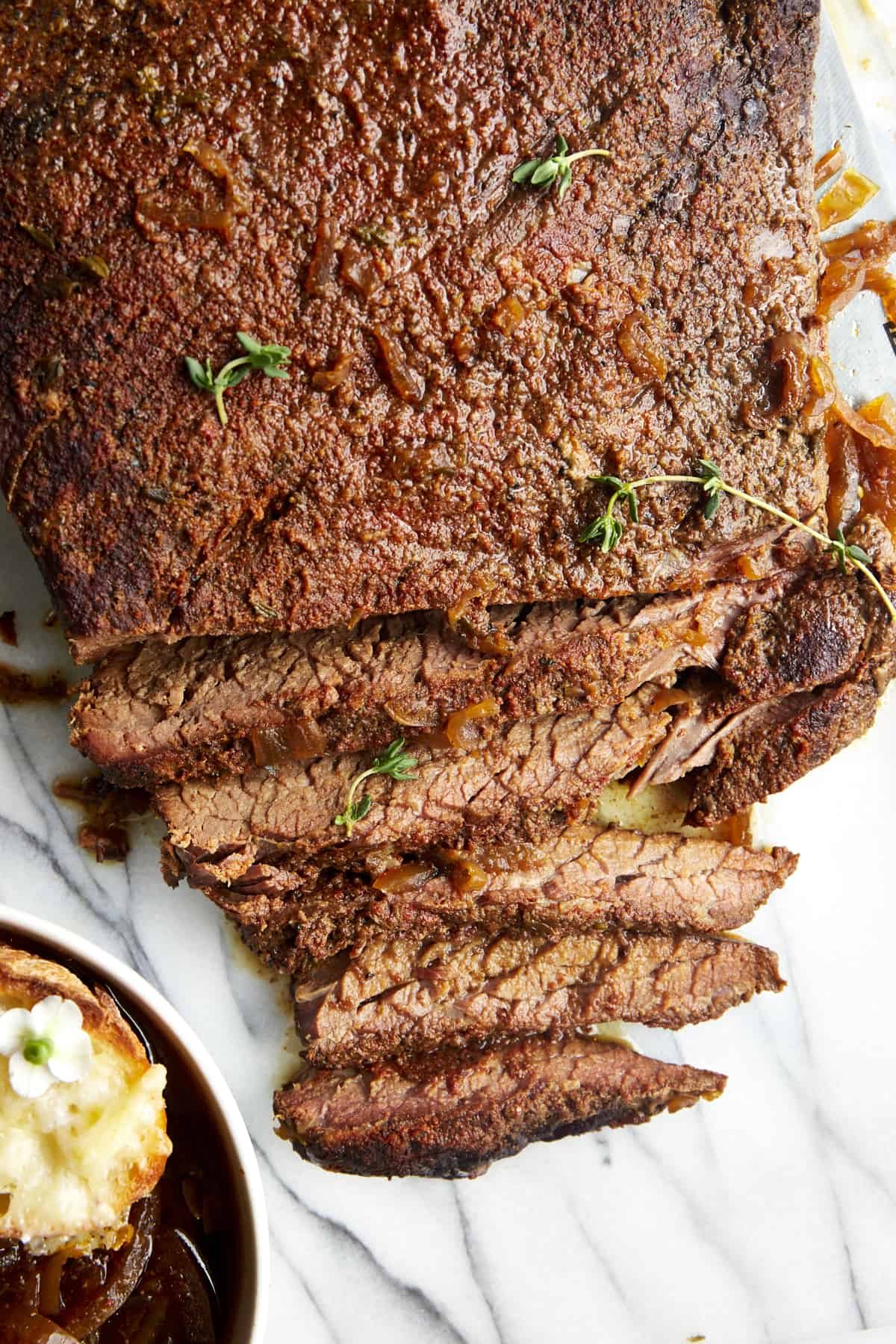 Slow cooker beef brisket with a few strips sliced.