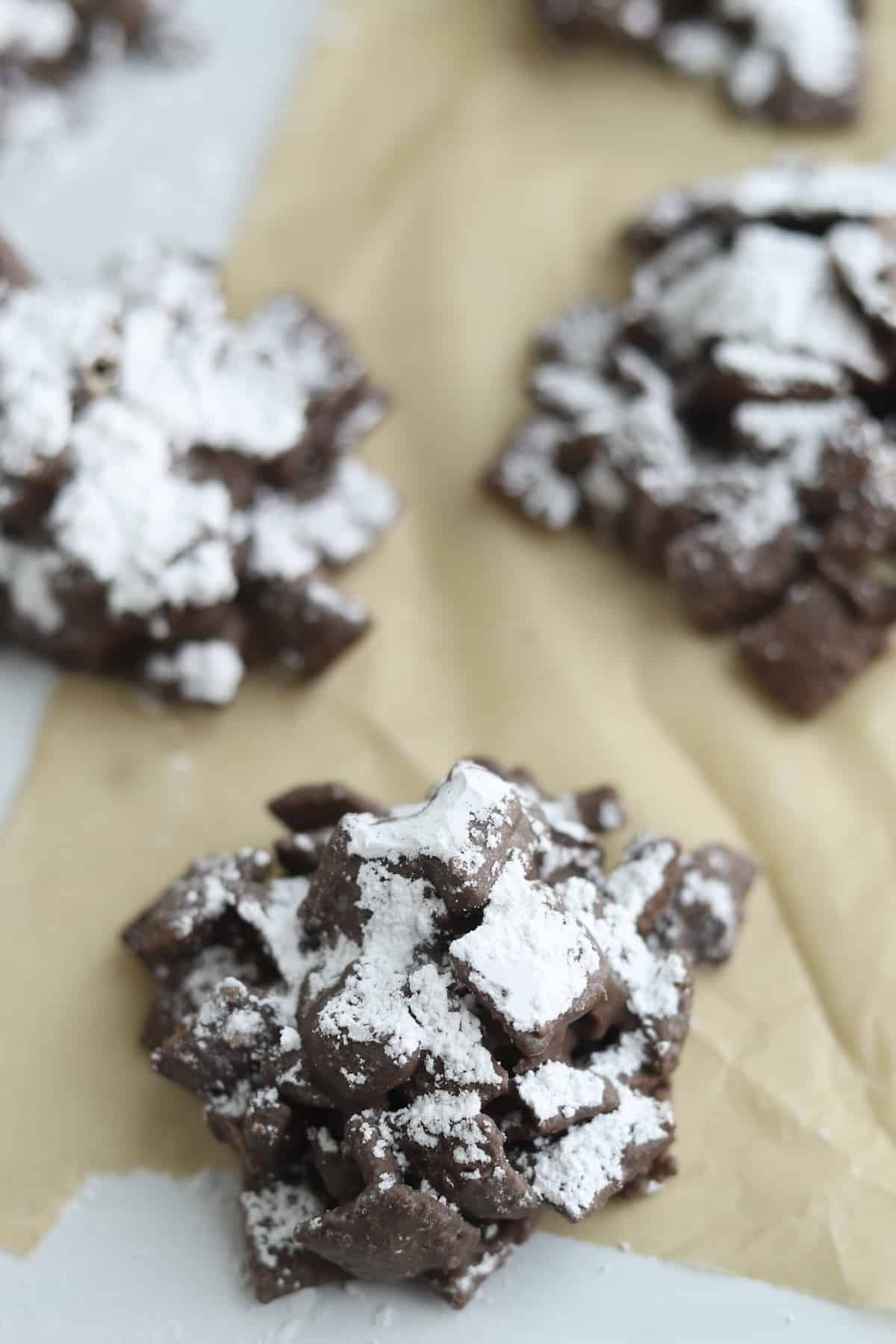 puppy chow on wax paper with powdered sugar