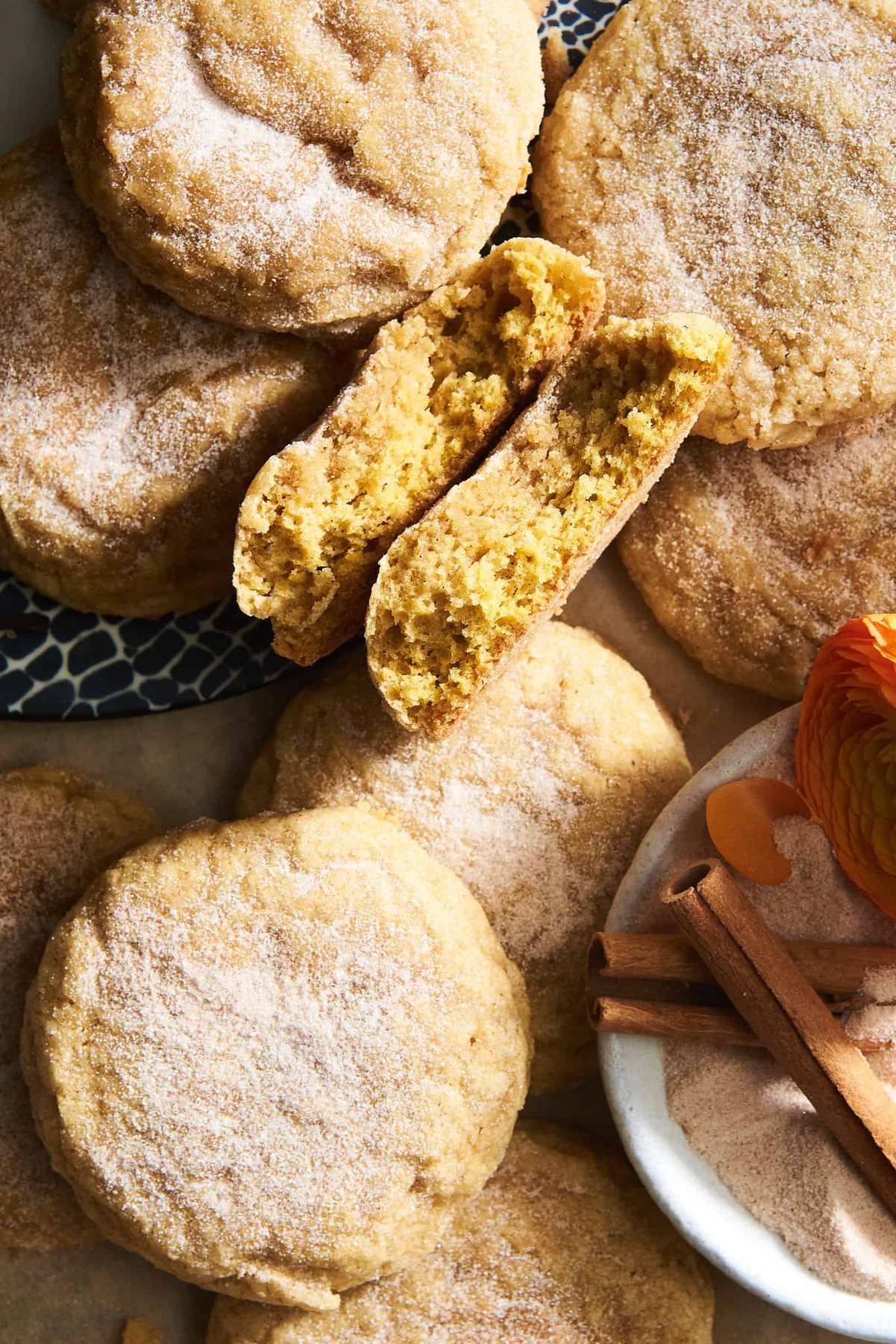 Soft pumpkin cookies with one split in half.