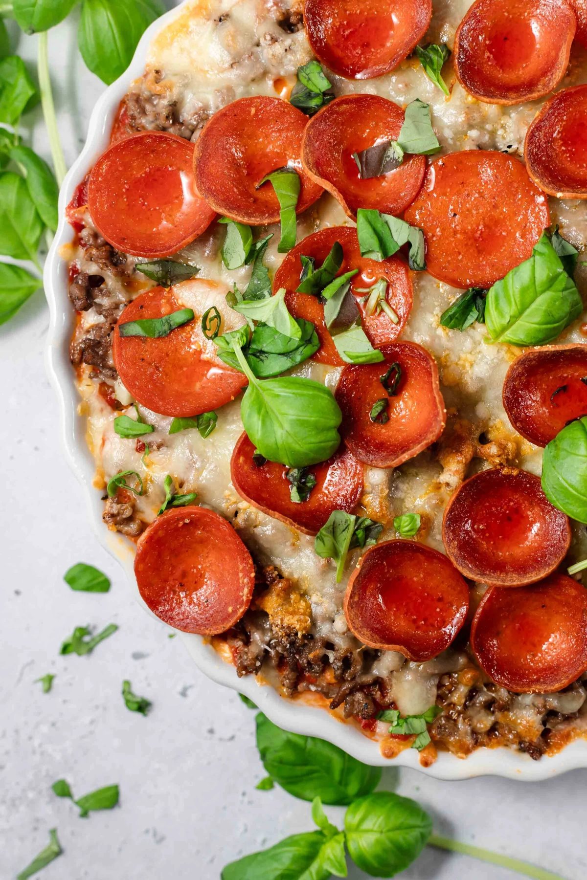 spaghetti pizza topped with pepperonis