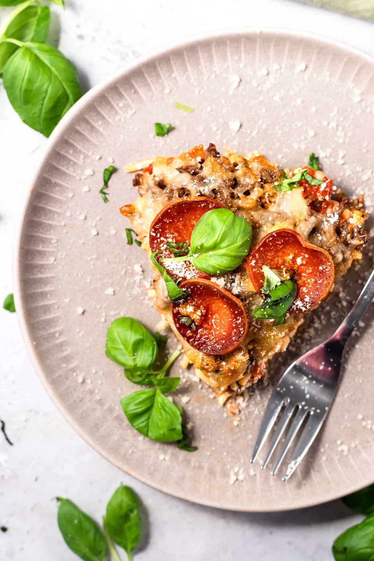 a slice of pizza spaghetti bake on a plate