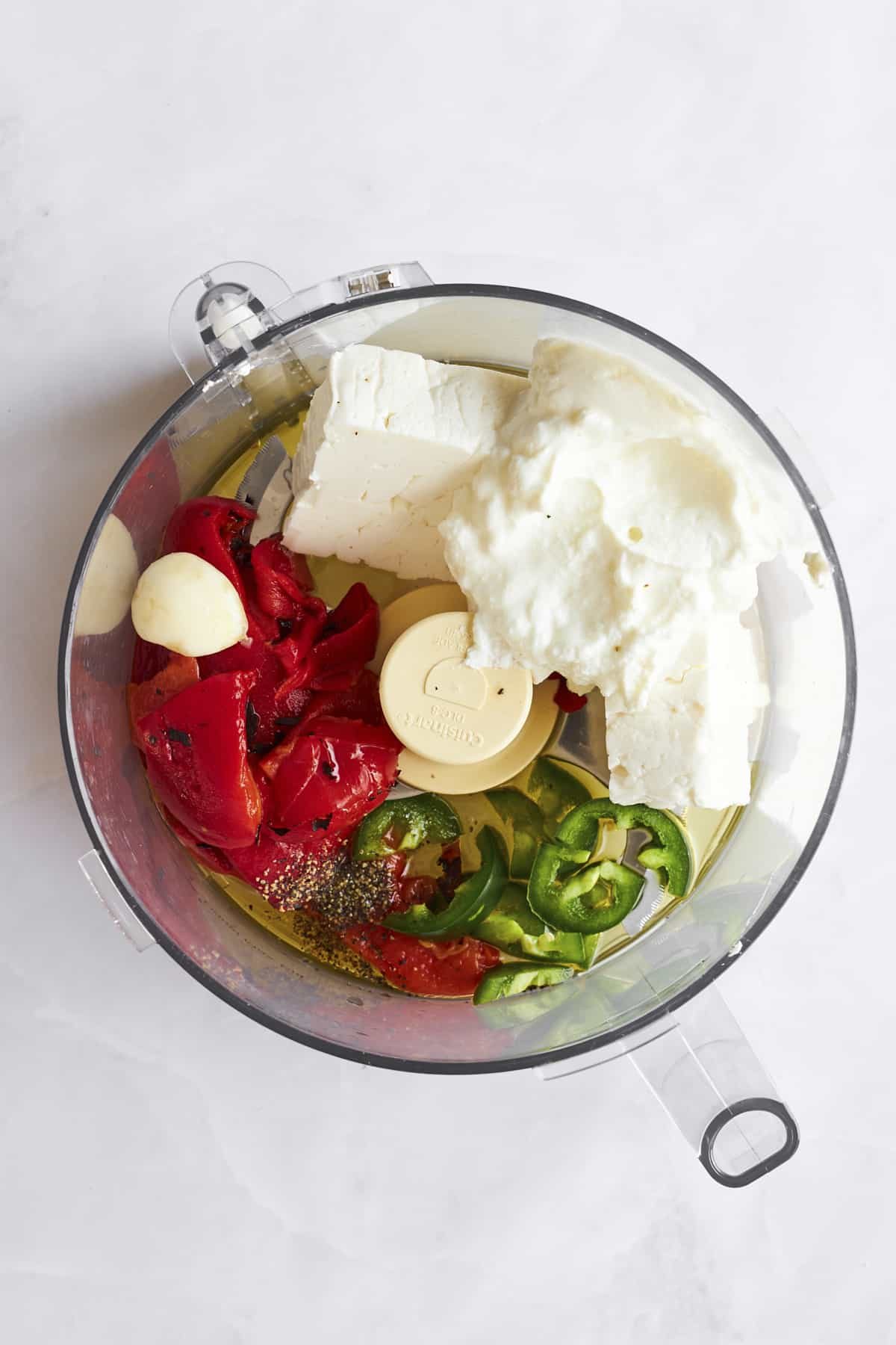 Ingrediens to make spicy feta dip in a food processor.