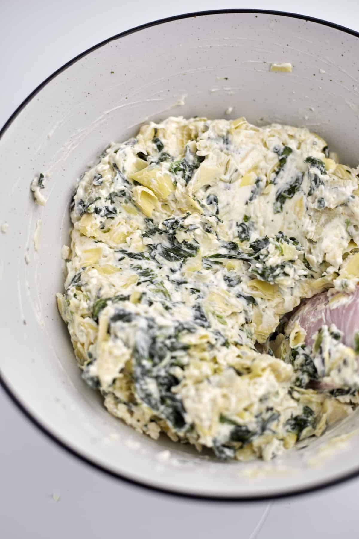 spinach and artichoke mixture in a white bowl