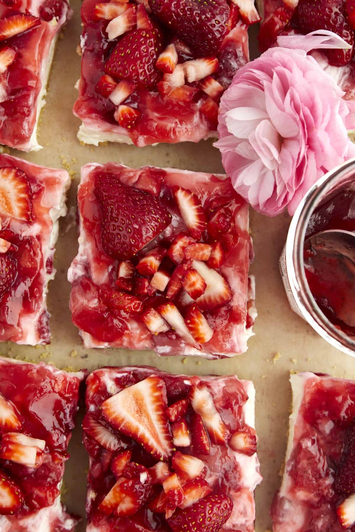 Overhead image of sliced strawberry cheesecake bars.