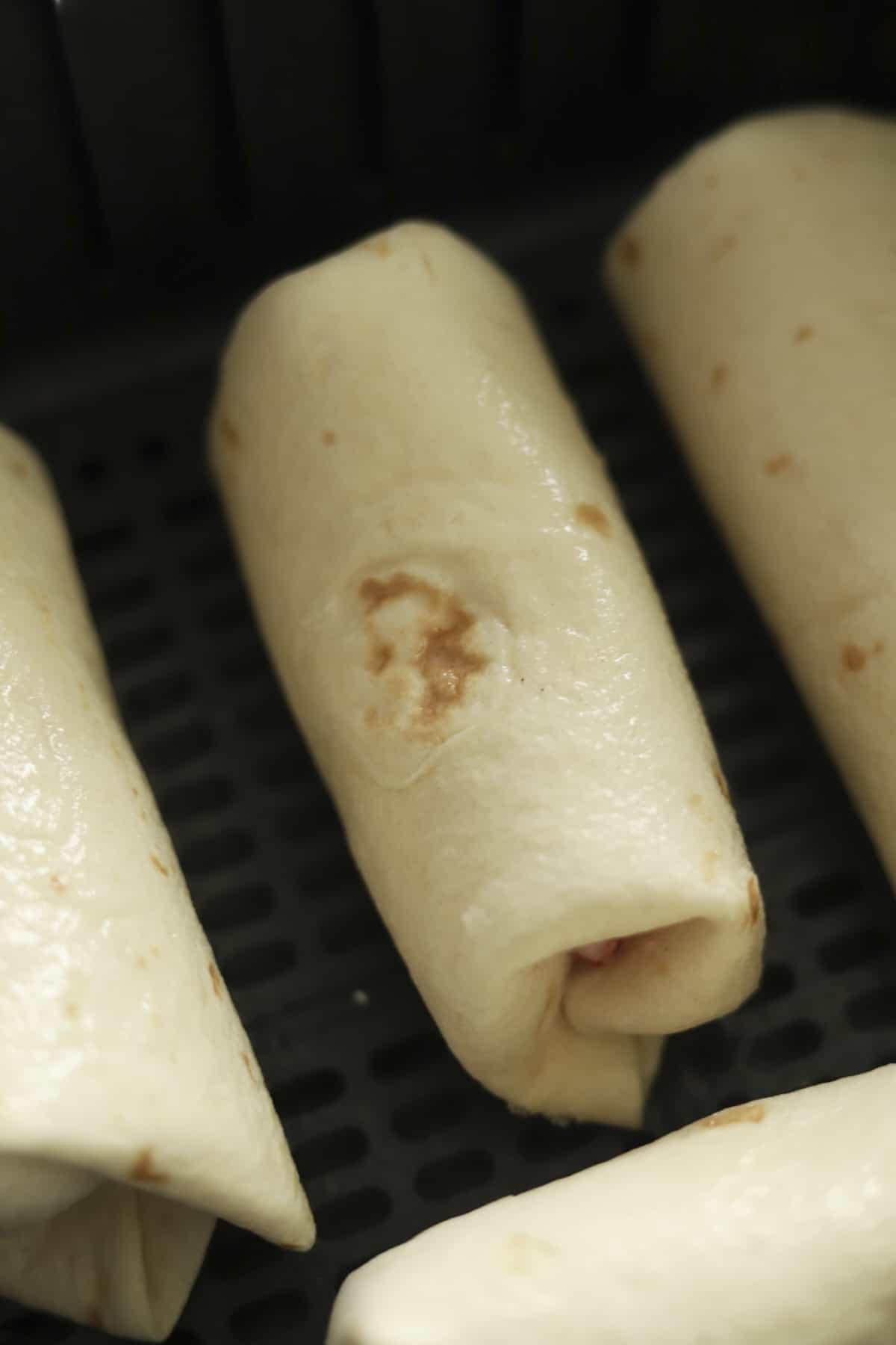 strawberry cheesecake chimichangas in an air fryer