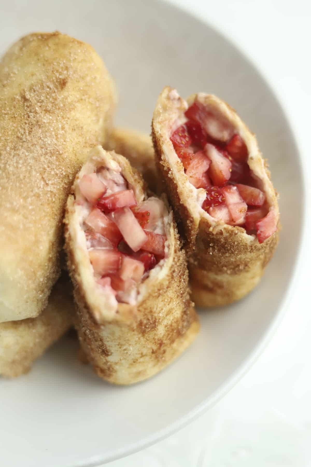 opened stuffed chimichanga with fresh strawberries