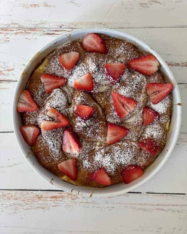 overhead image of a baking dish full of strawberry cheesecake french toast croissants