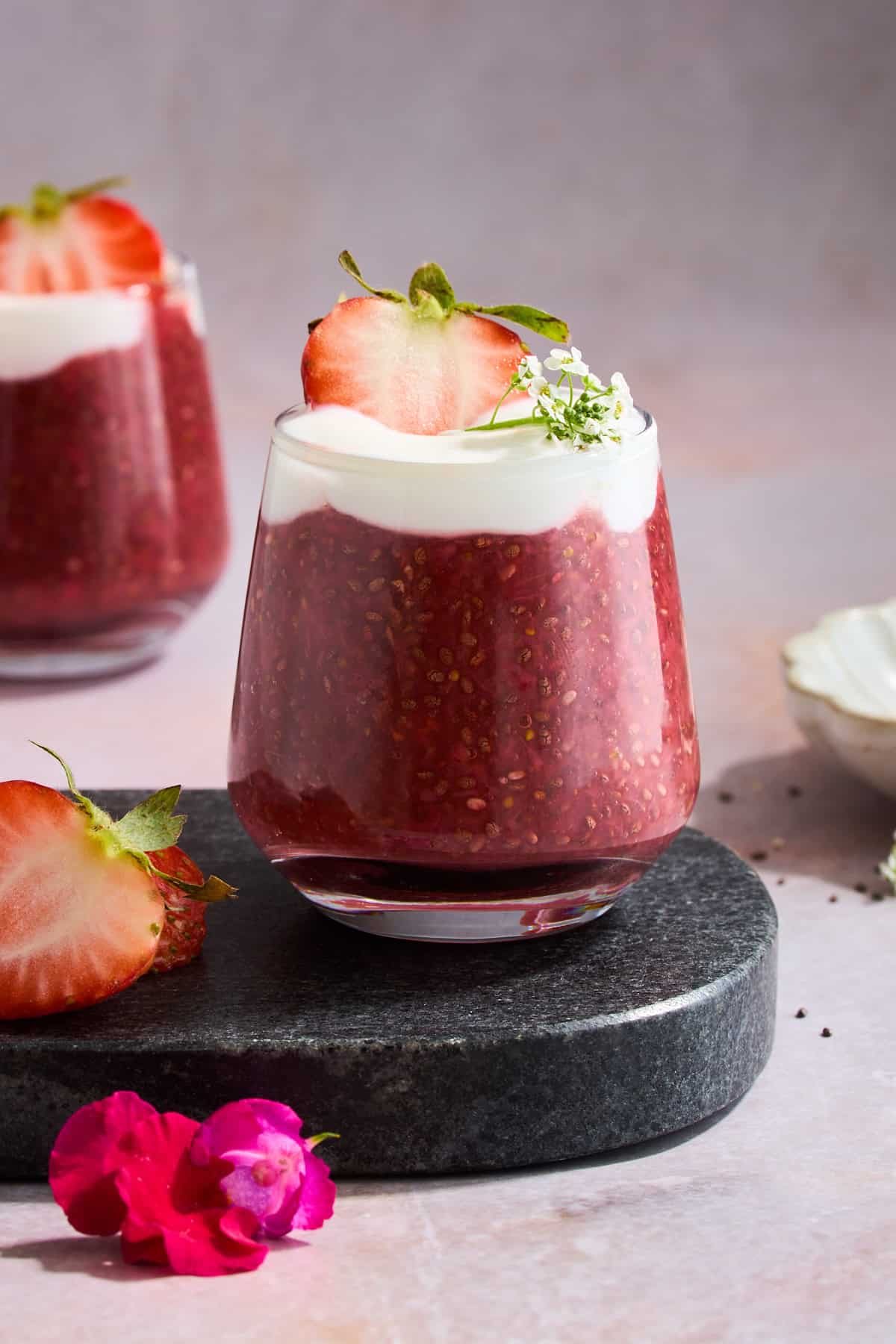 A jar of strawberry chia pudding topped with Greek yogurt.
