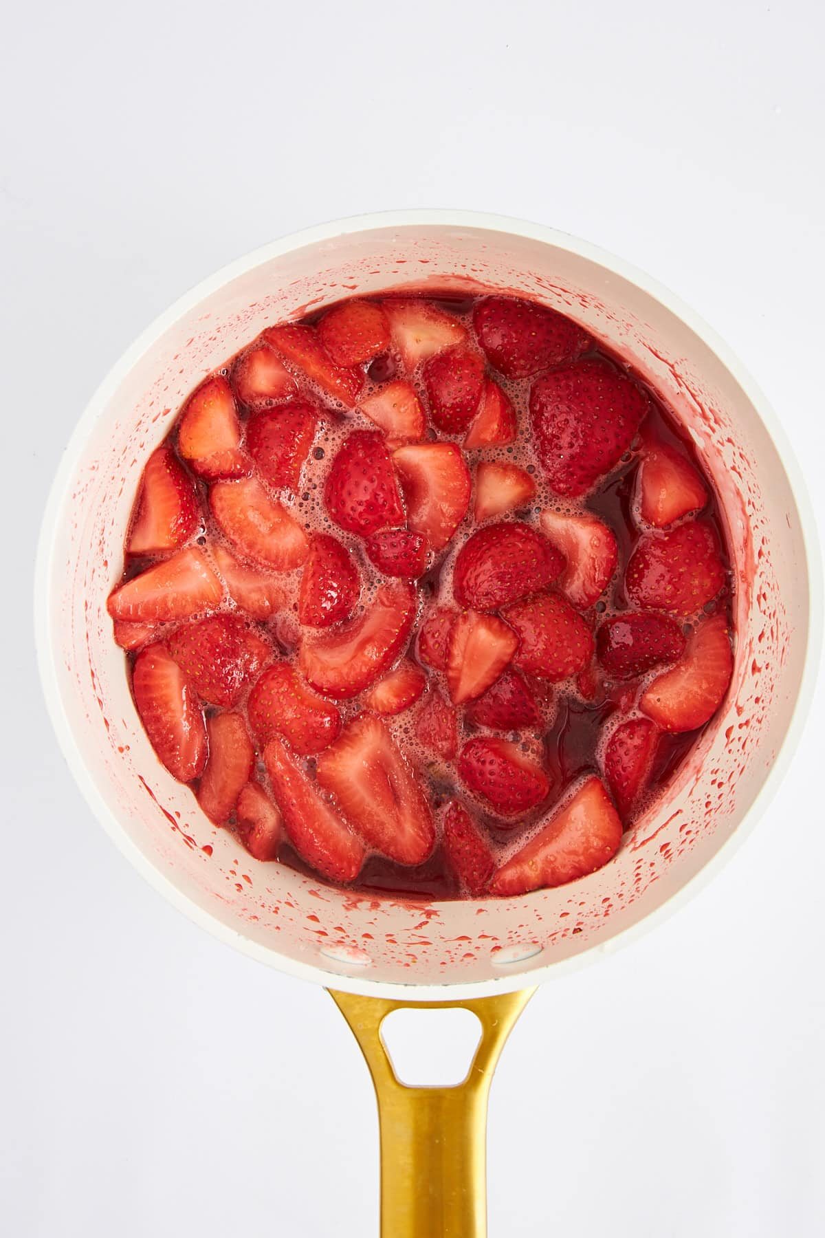 Strawberries cooking in a saucepan.