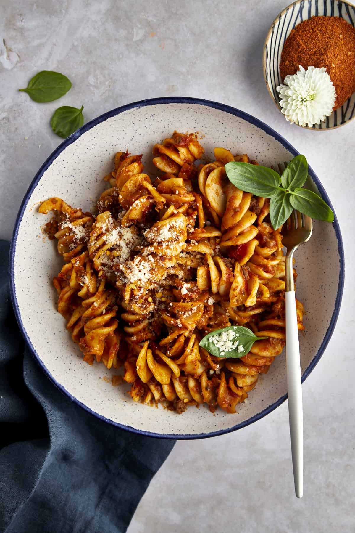 Overhead image of a bowl of taco pasta with a fork on the side.