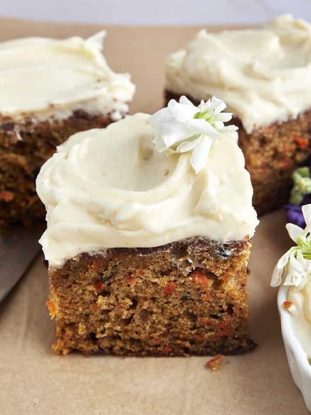 A square of easy carrot cake topped with cream cheese frosting.