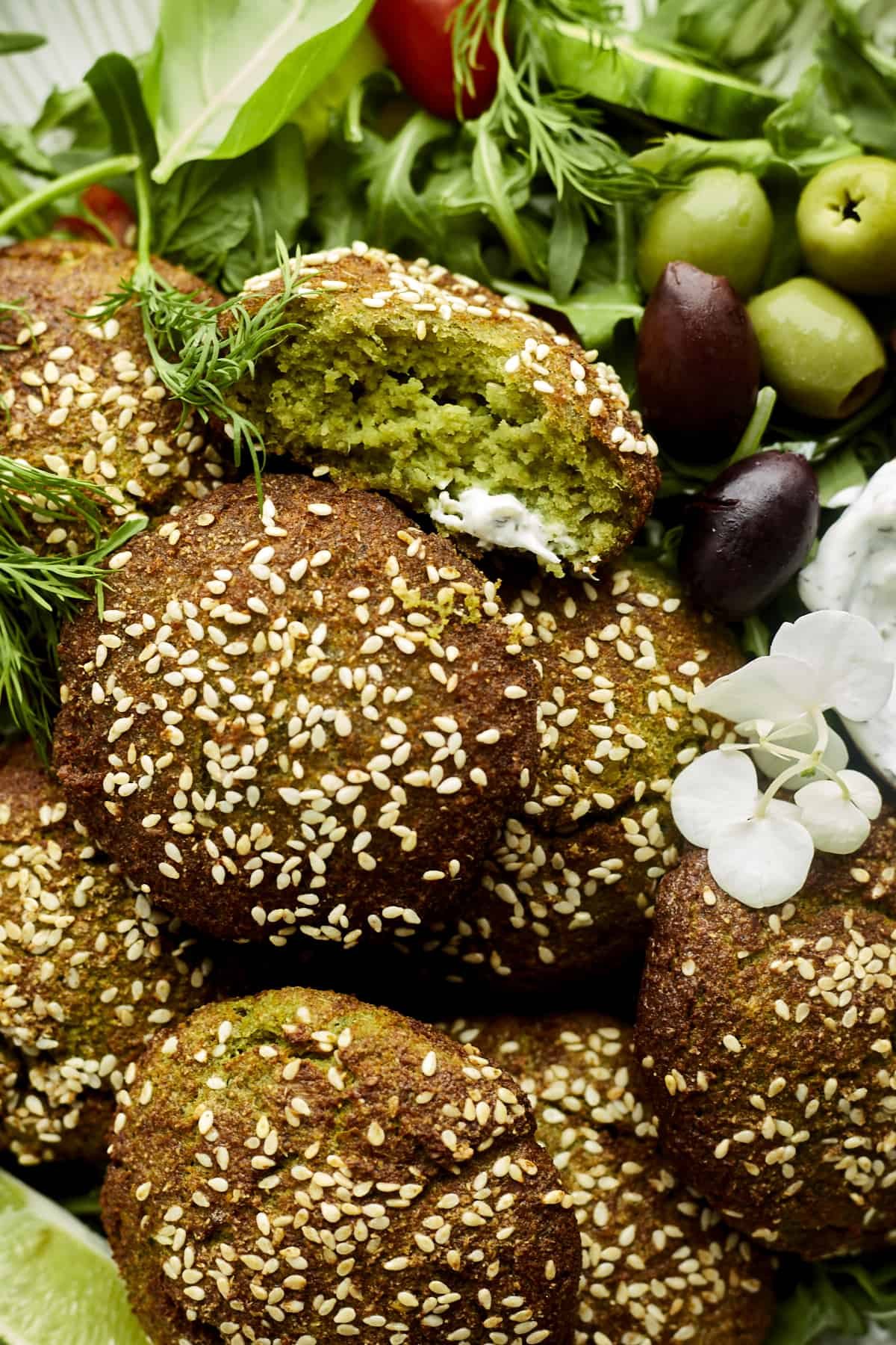 Falafel balls topped with white sesame seeds.