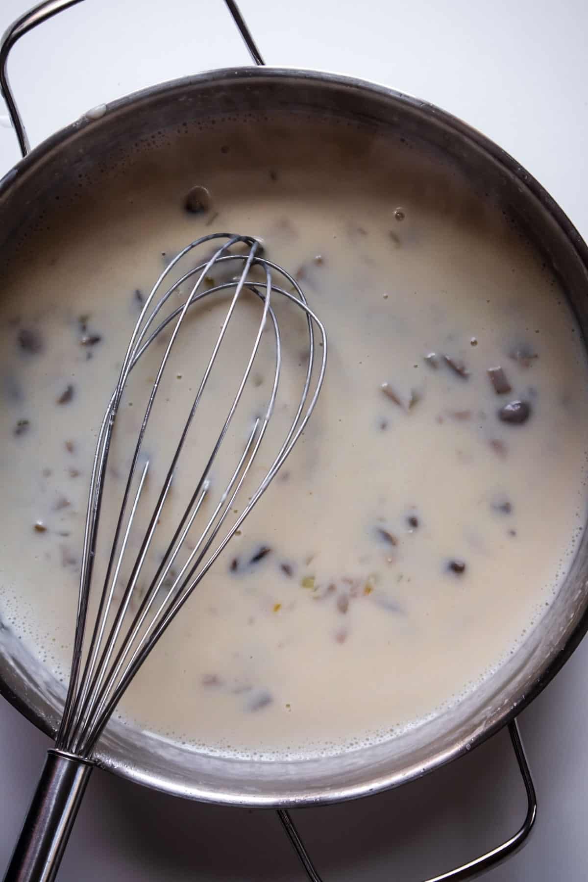 roux in a pot with a whisk on top.