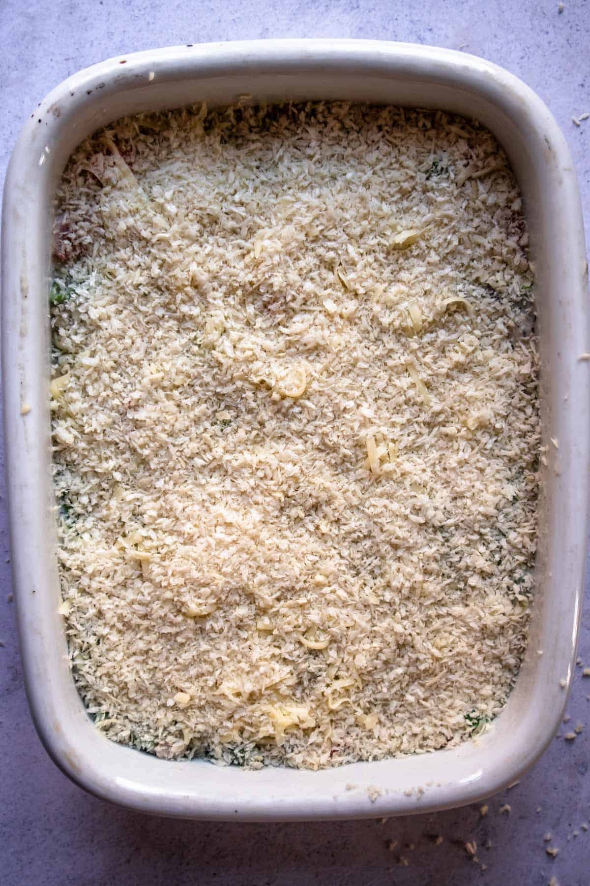 breadcrumbs over a casserole in a baking dish.