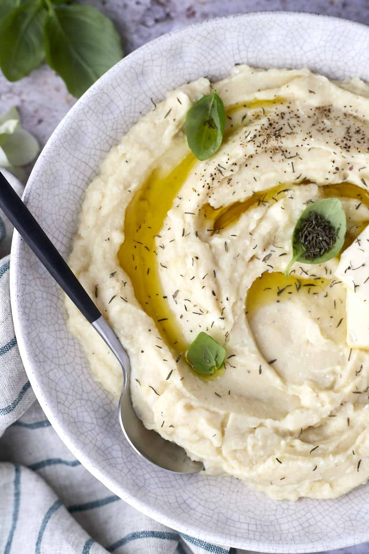 A bowl of cheesy baked mashed potatoes.