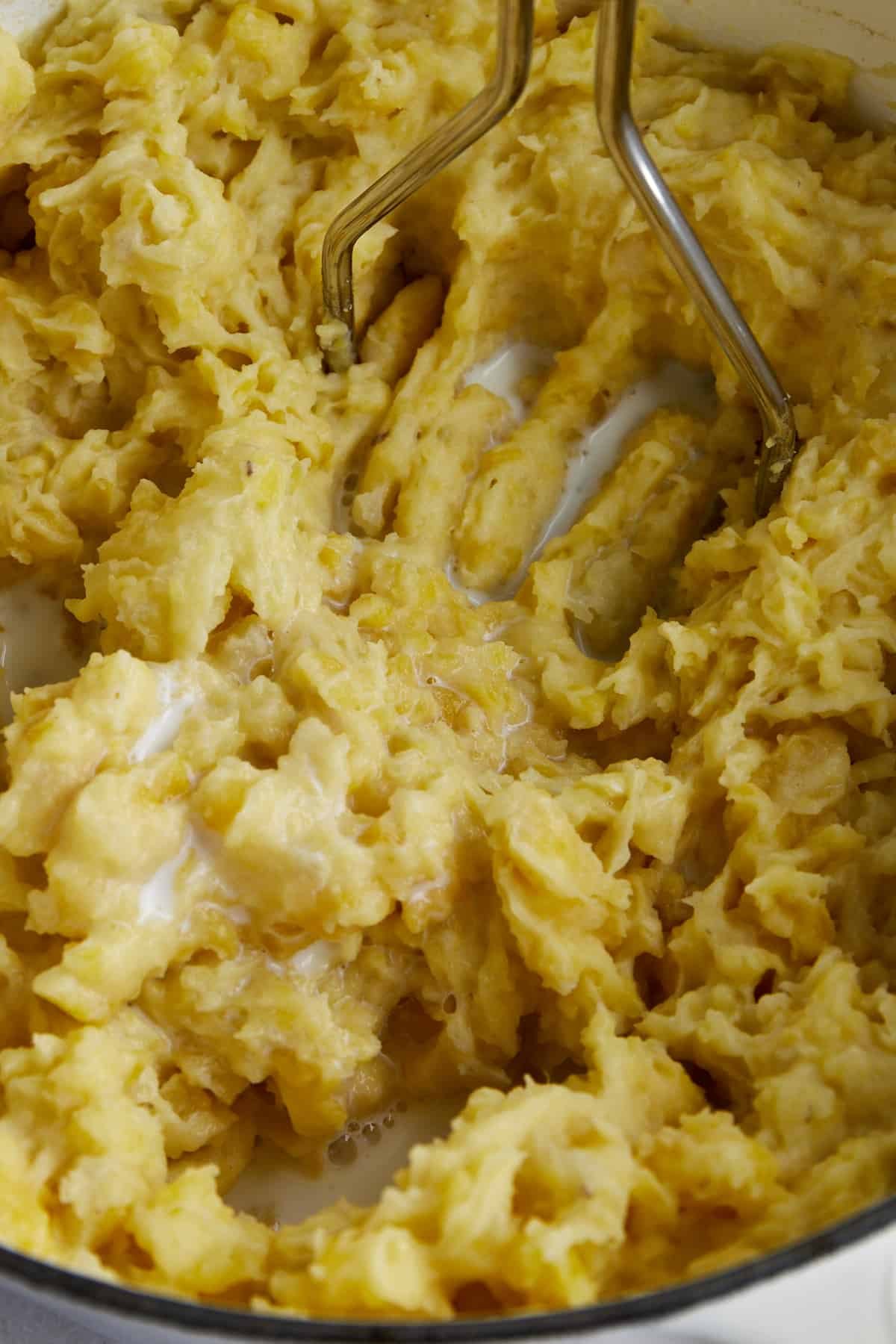 Mashed potatoes being combined with milk.