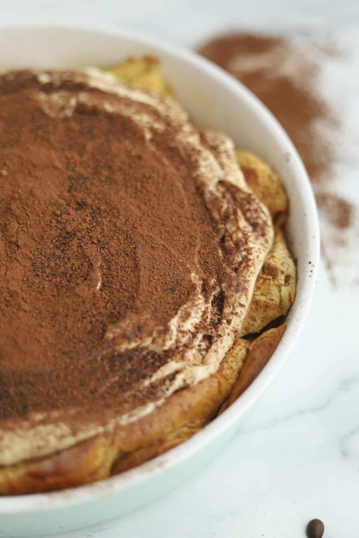 close up image of tiramisú bread pudding in a baking dish