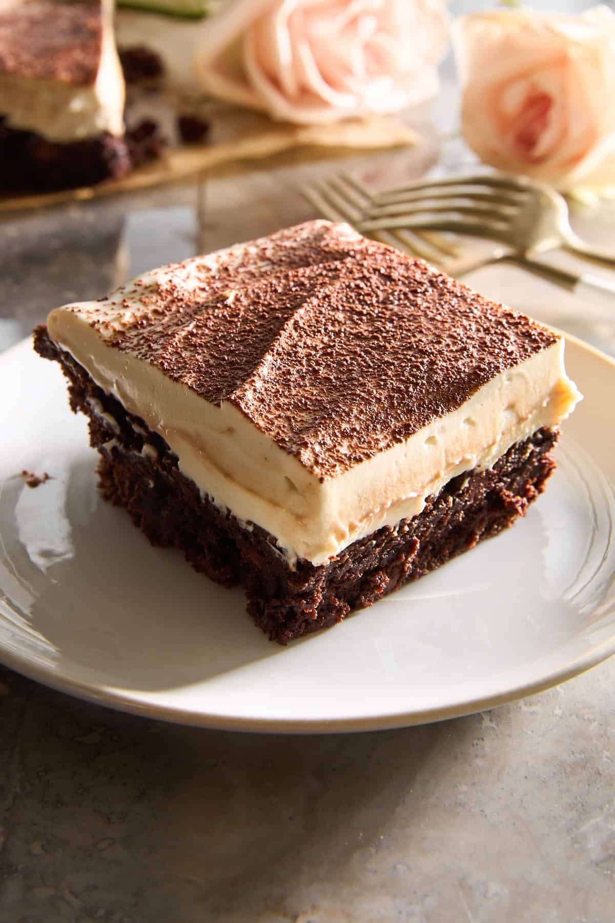 A tiramisu brownie with mascarpone topping on a plate.