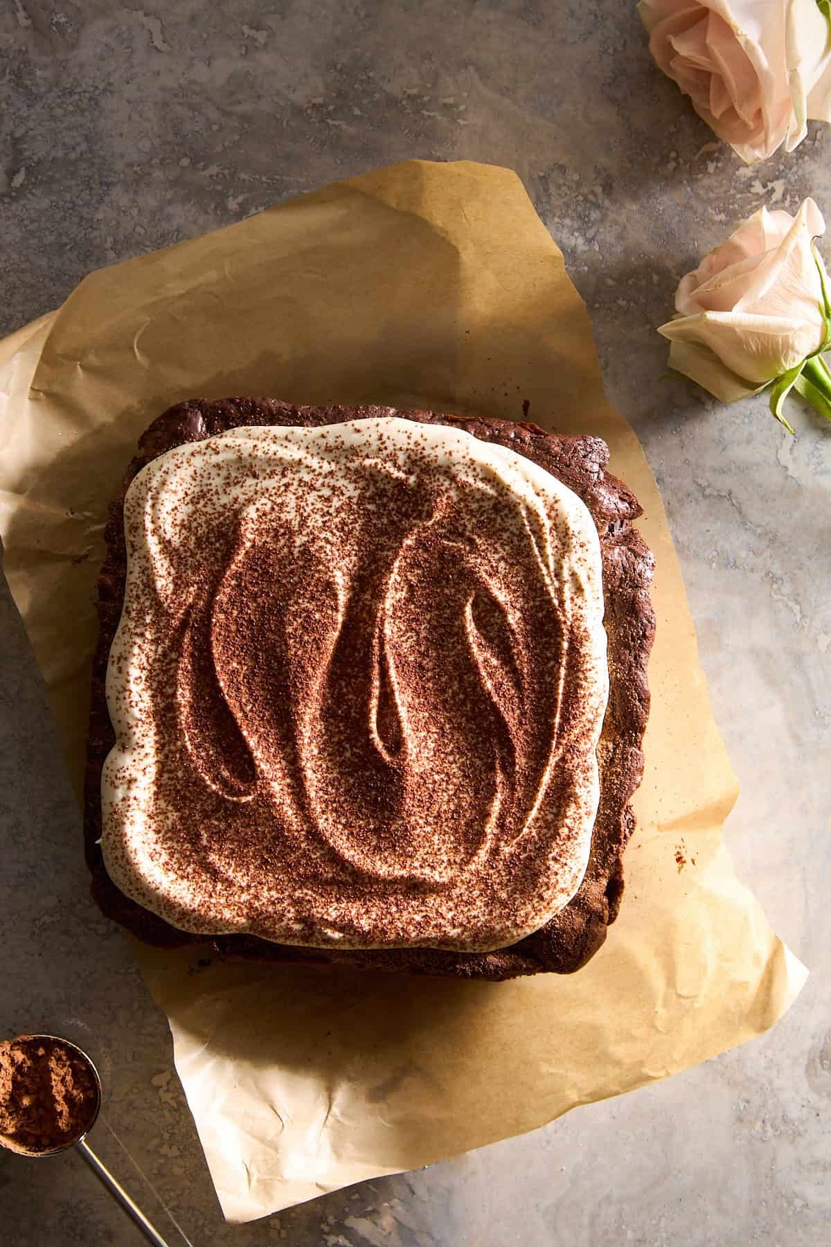 Tiramisu brownies topped with mascarpone and cocoa powder.
