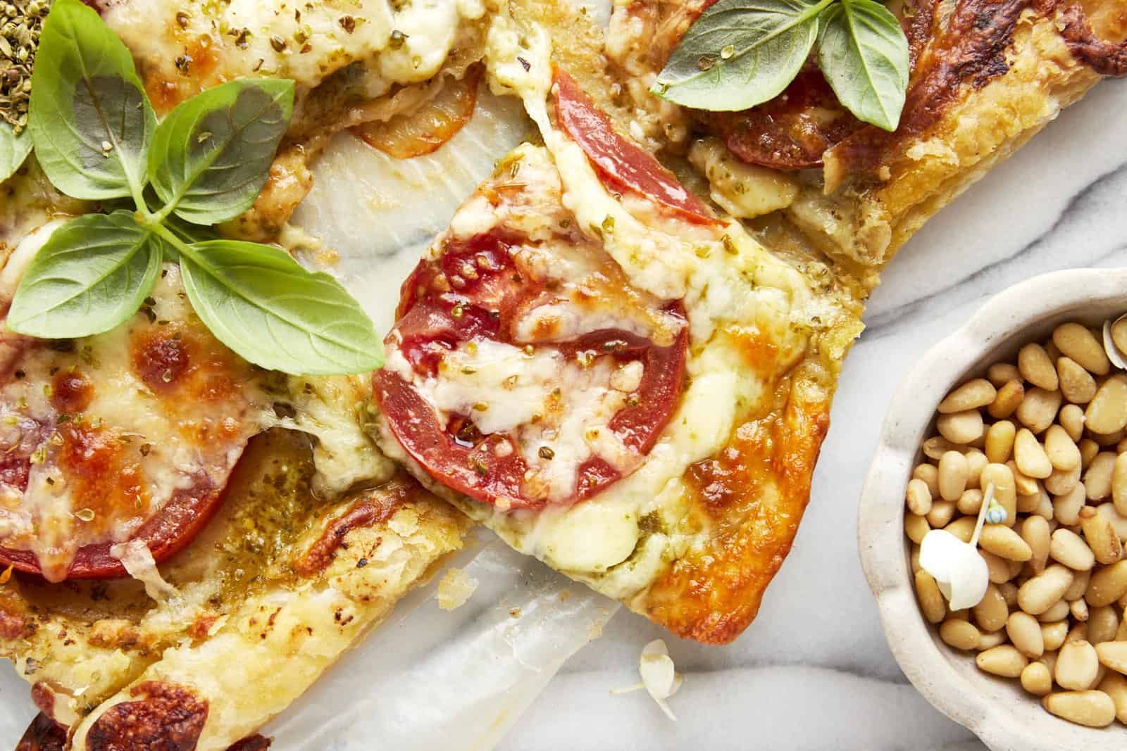 Slices of baked tomato pesto puff pastry.