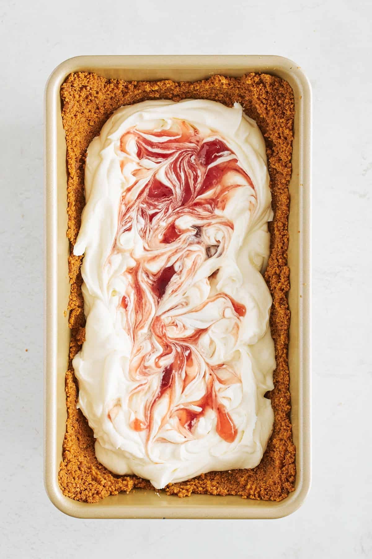 Strawberry preserves swirled into cheesecake filling in Biscoff crust.