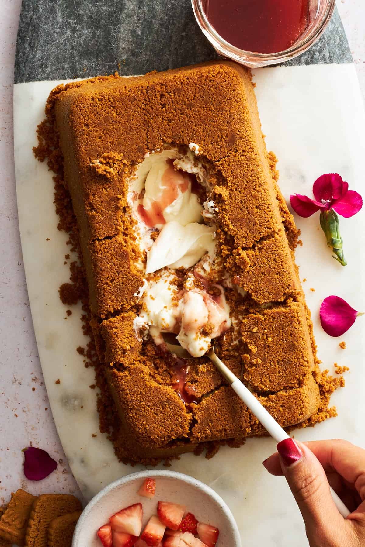 A spoon digging into the silky center of an upside down cheesecake.