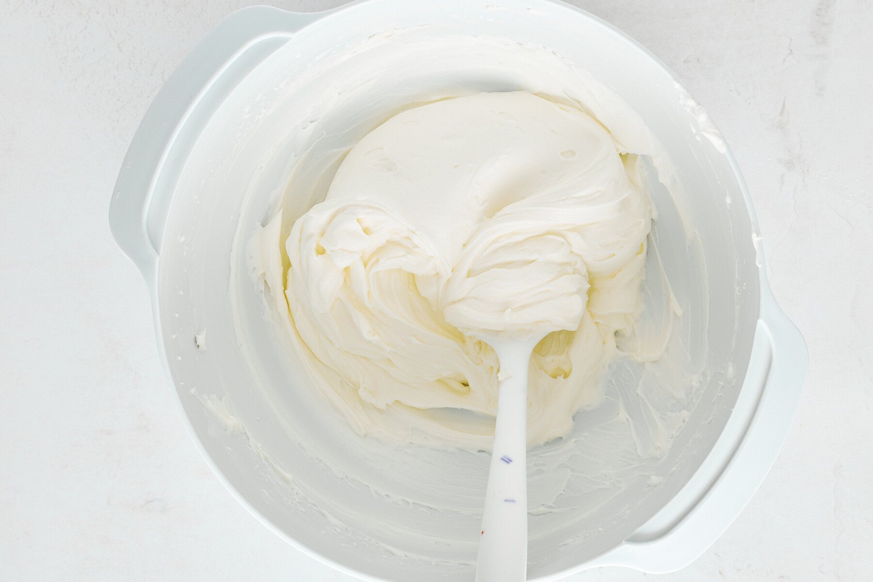 Cheesecake filling in a mixing bowl.