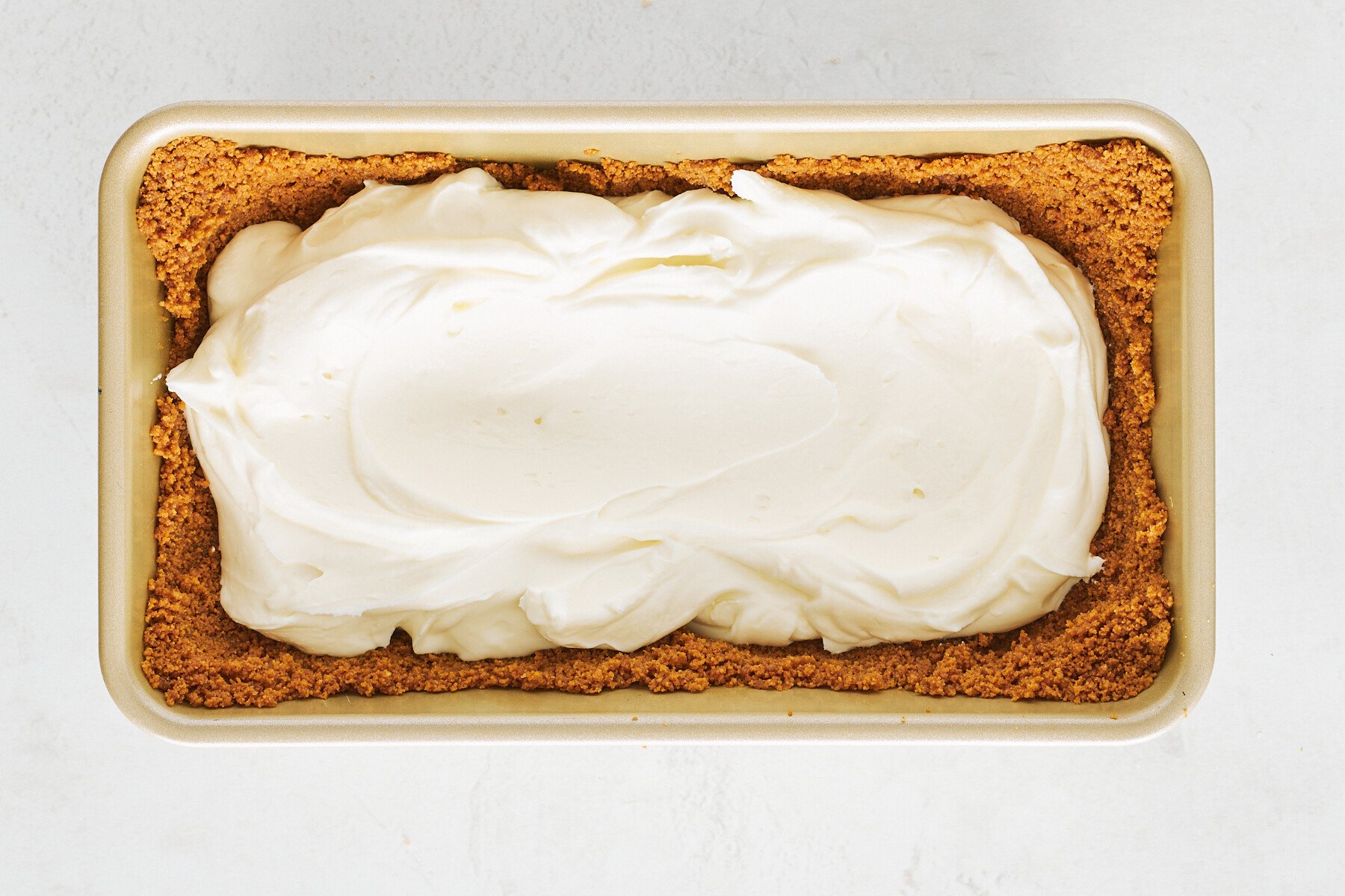 Cream cheese filling in a Biscoff cookie crust in a loaf pan.