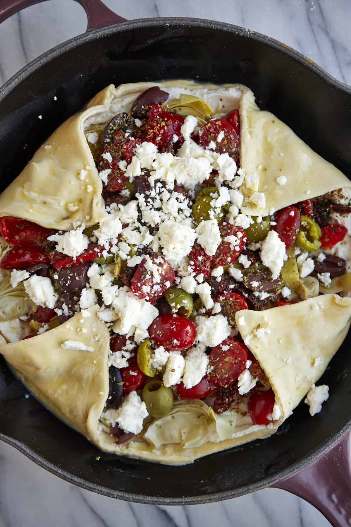 An unbaked Mediterranean vegetable galette.