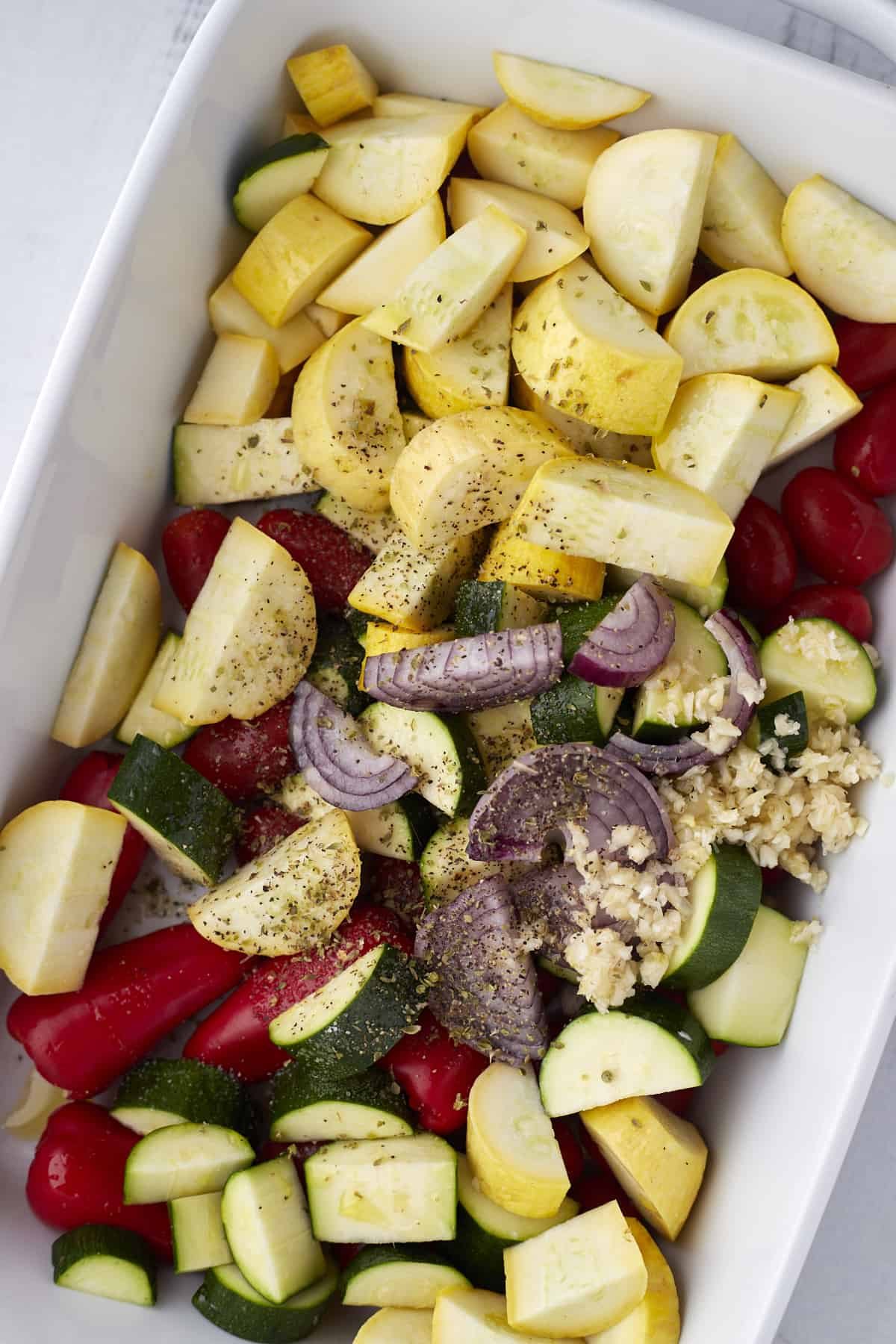 chopped veggies in a white baking dish
