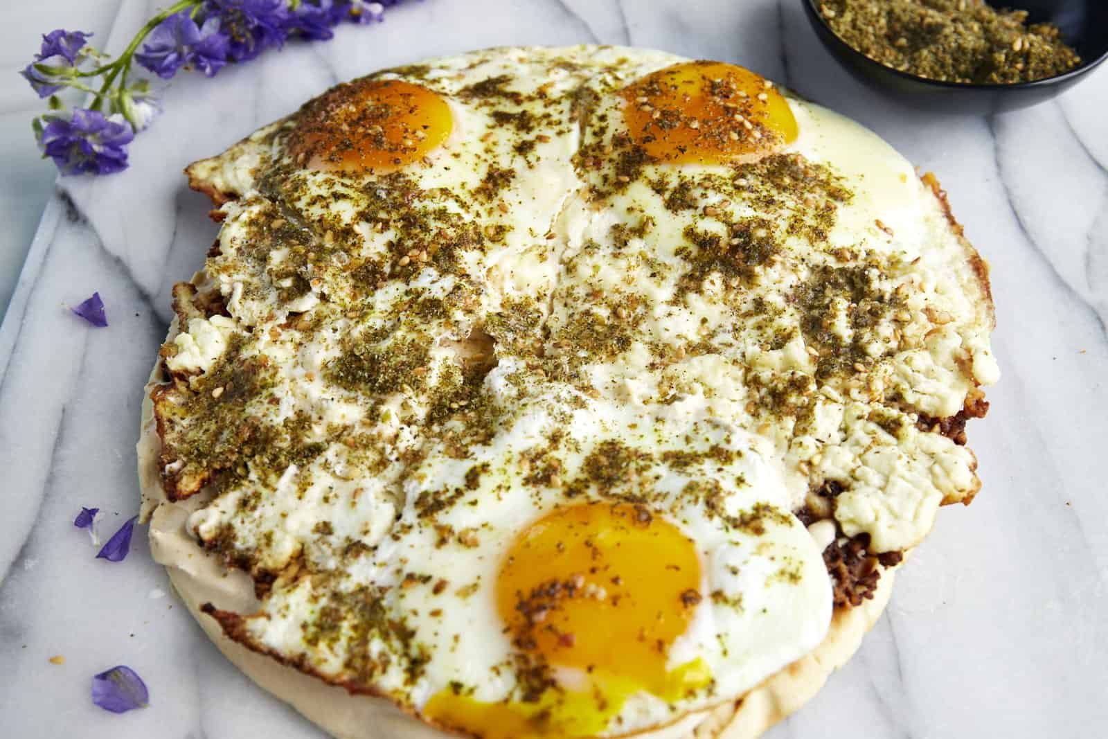 Viral feta fried eggs topped with za'atar and served on pita bread topped with hummus.