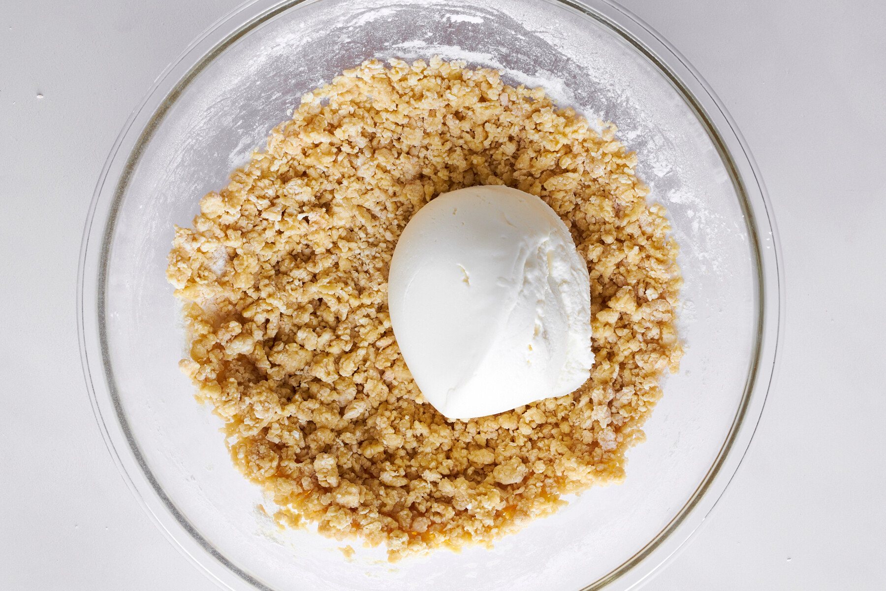 Ricotta cheese and zeppole dough in a bowl.