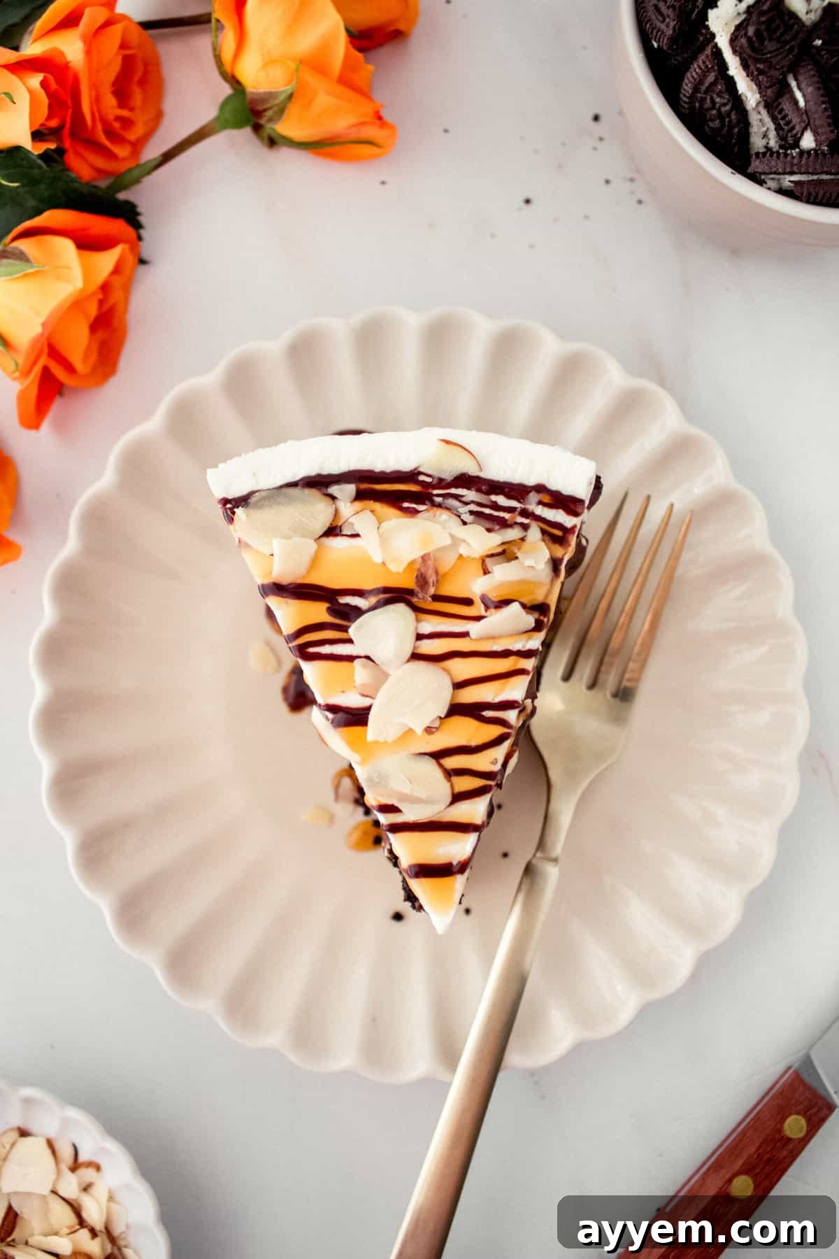 An overhead shot of a slice of Billy Miner Ice Cream Pie presented on a plate, with a fork ready to scoop into its delicious layers.