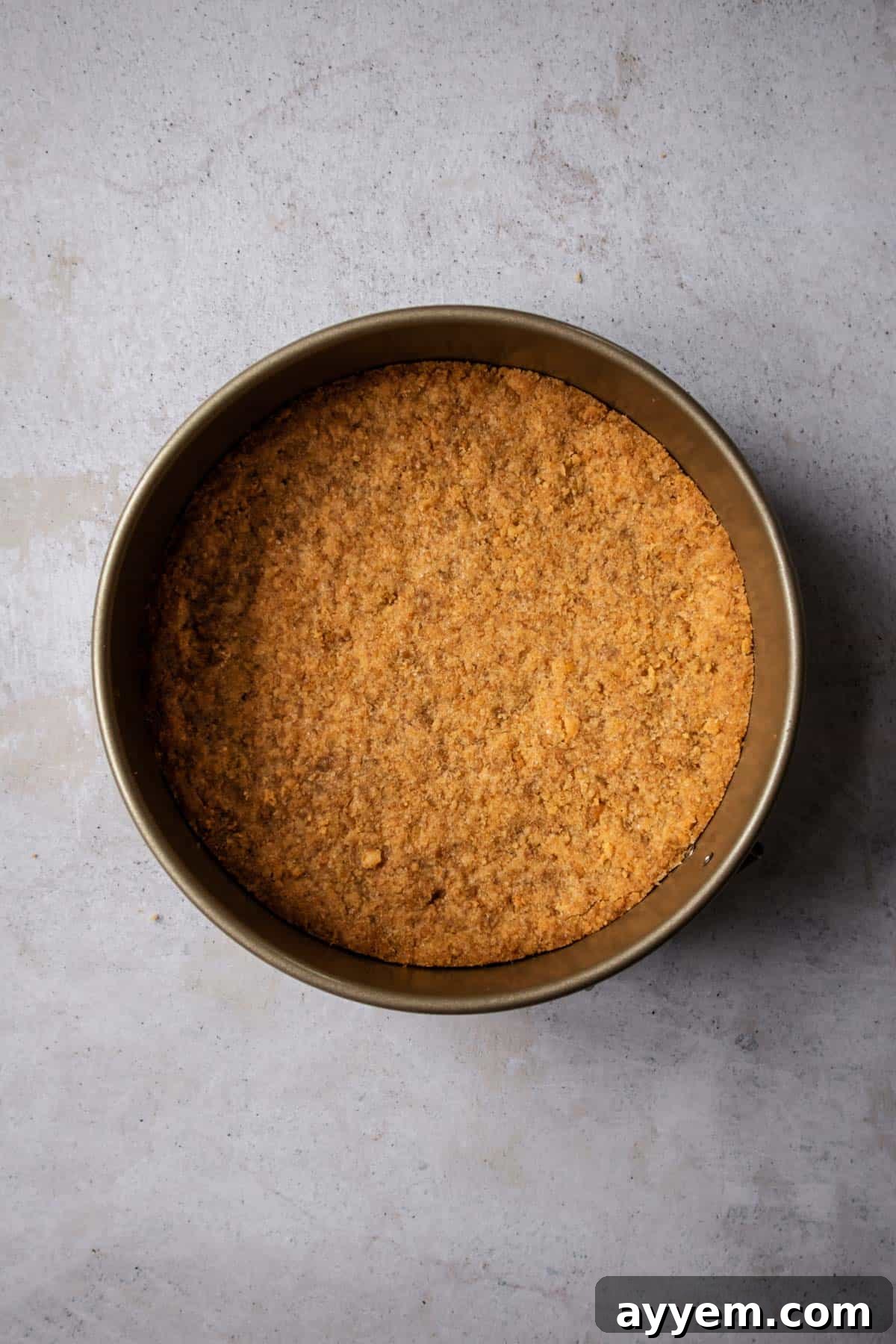 A sturdy graham cracker crust pressed into the bottom of a round cake pan, forming the perfect base for a Banoffee Cream Pie.