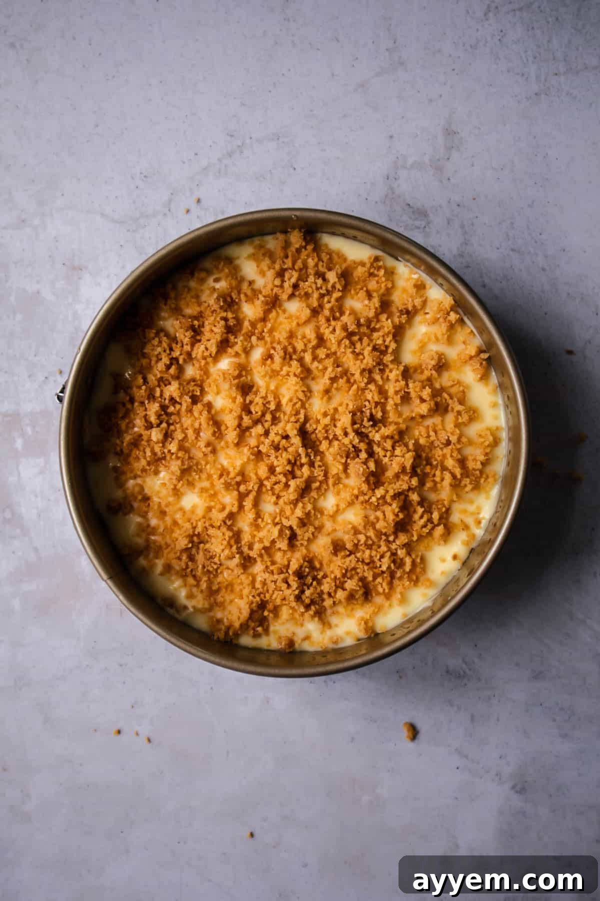 A light sprinkling of reserved graham cracker crumbs artfully spread on top of the smooth pudding layer, adding a textural contrast to the banoffee pie.