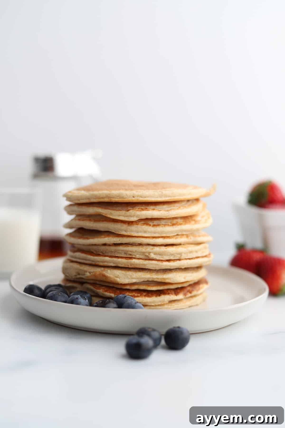 A stack of perfectly cooked cottage cheese protein pancakes on a plate, ready to be enjoyed as a healthy and delicious breakfast.