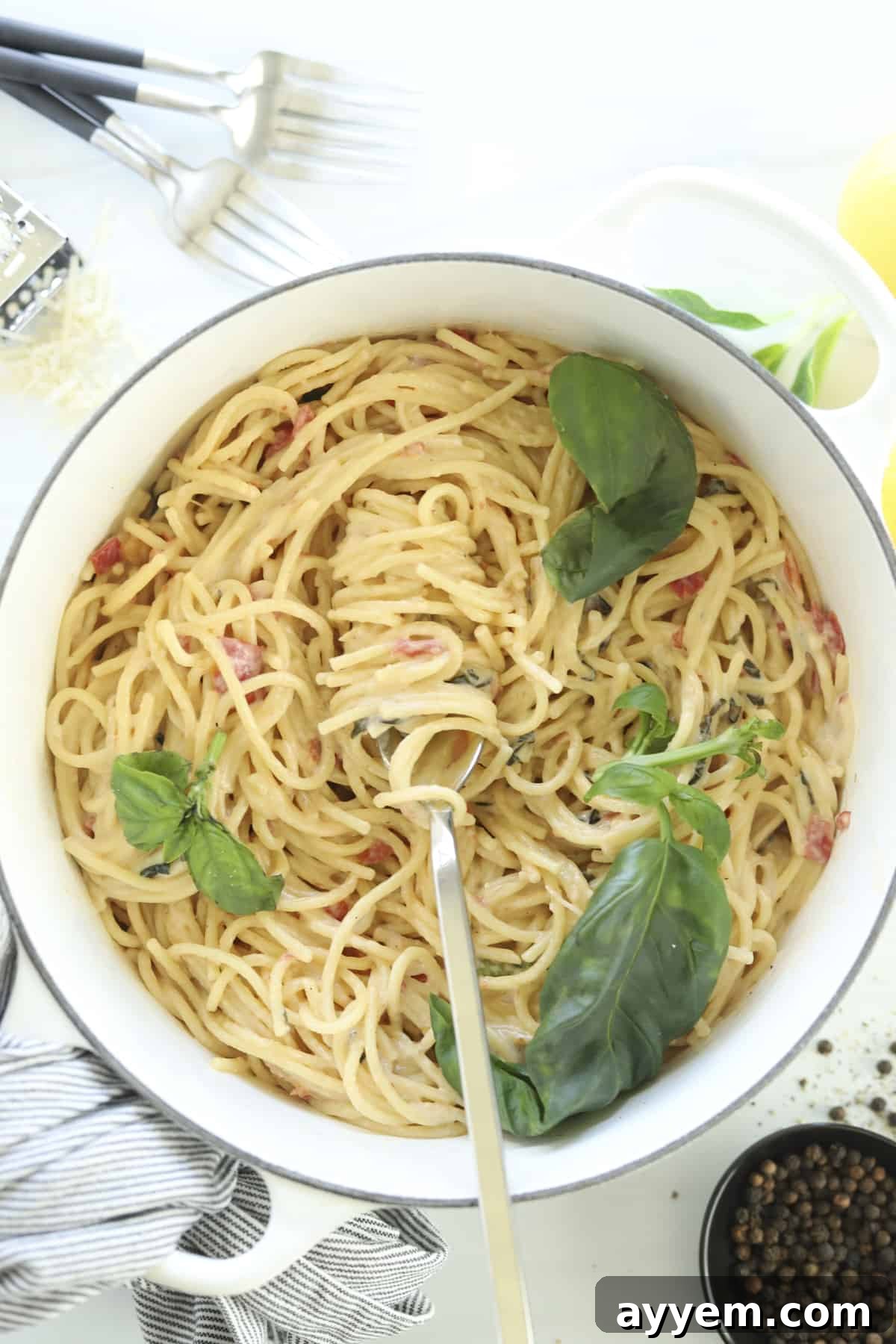 Overhead view of a pot of creamy One-Pot Parmesan Pasta with a fork twirling a bite, ready to eat.