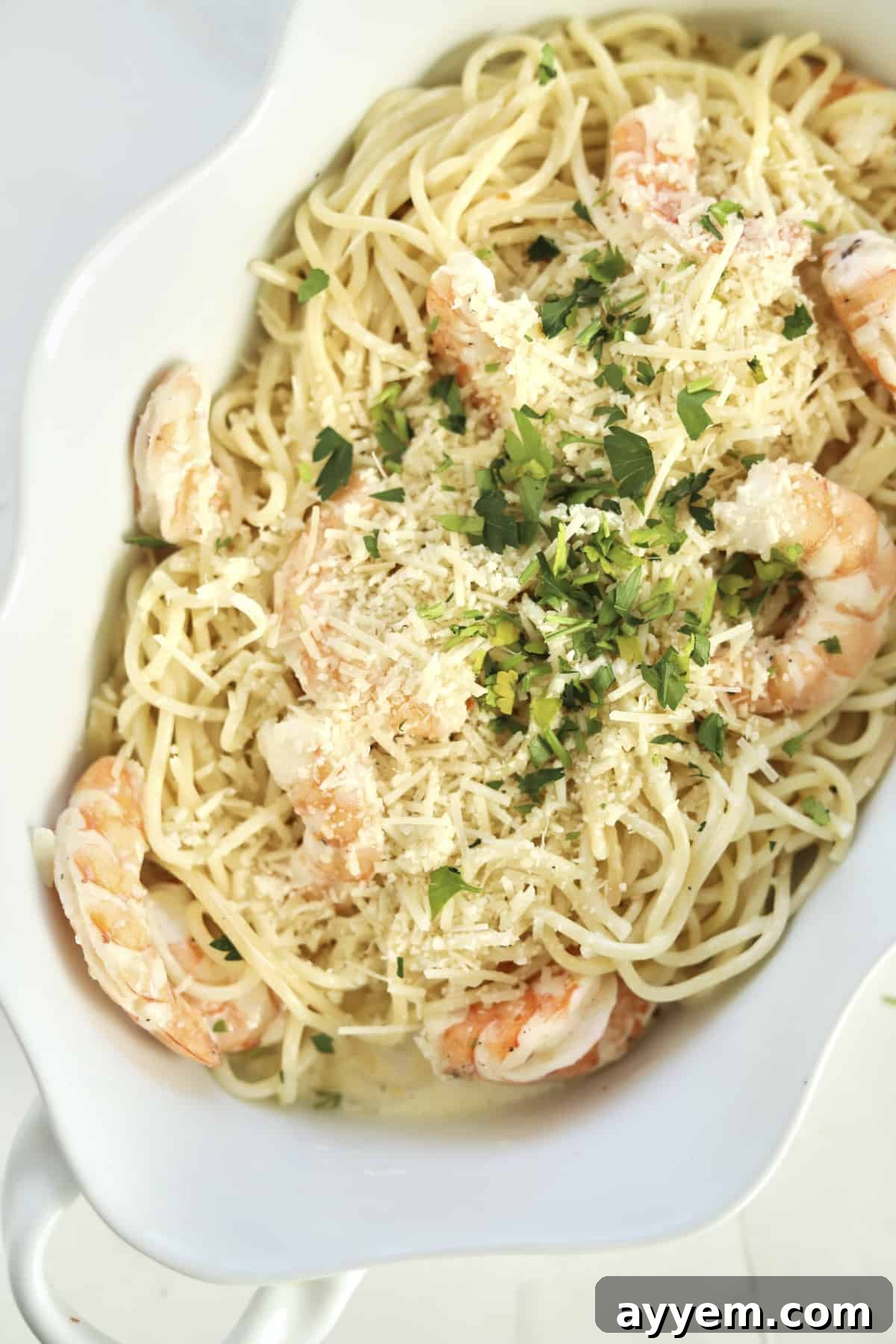 Golden Garlic Shrimp Bake 6 overhead garlic shrimp scampi in a baking dish with fresh parsley