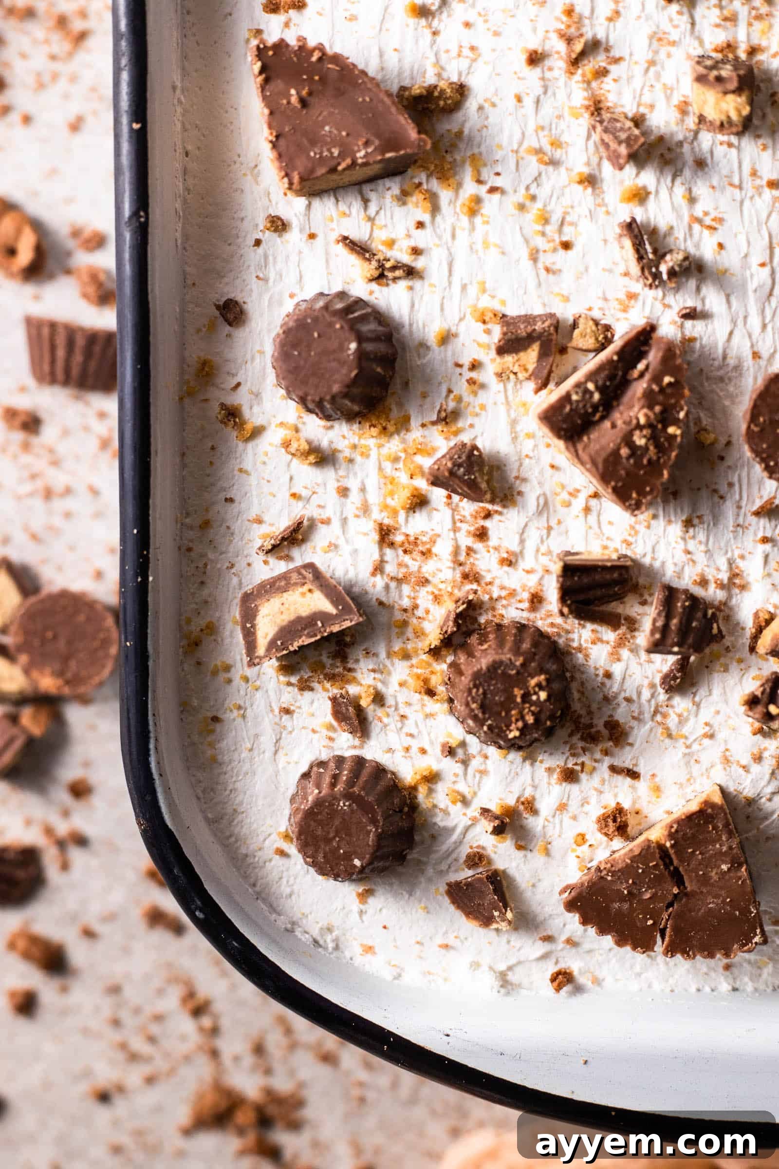 Close-up image of a no-bake dessert topped with peanut butter cups