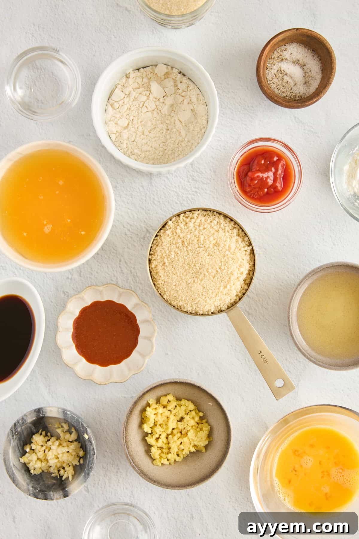 Ingredients for homemade orange chicken, laid out on a surface.
