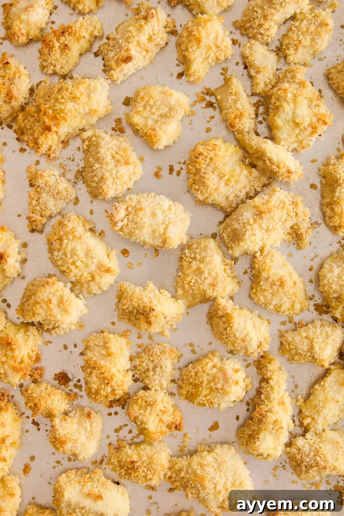 Cooked breaded chicken pieces, golden and crispy.