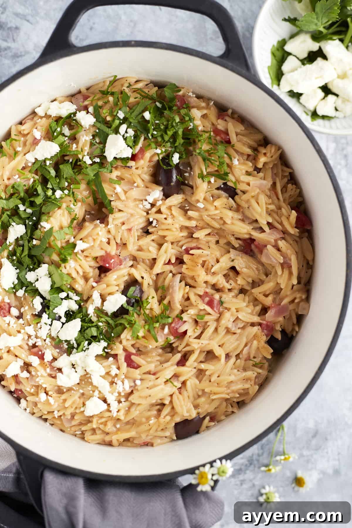 Overhead view of One Pot Mediterranean Orzo Pasta in a pot, ready to be served.