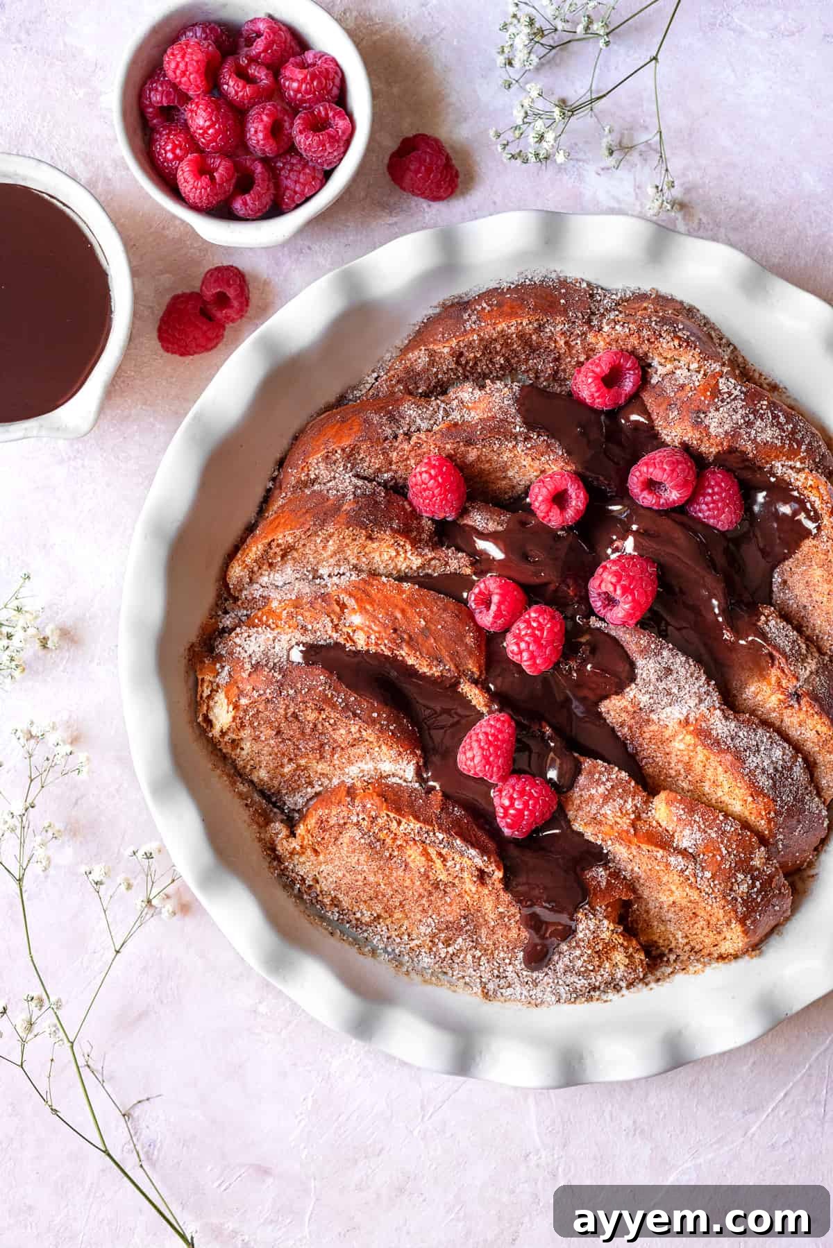overhead churro french toast with raspberries and chocolate sauce