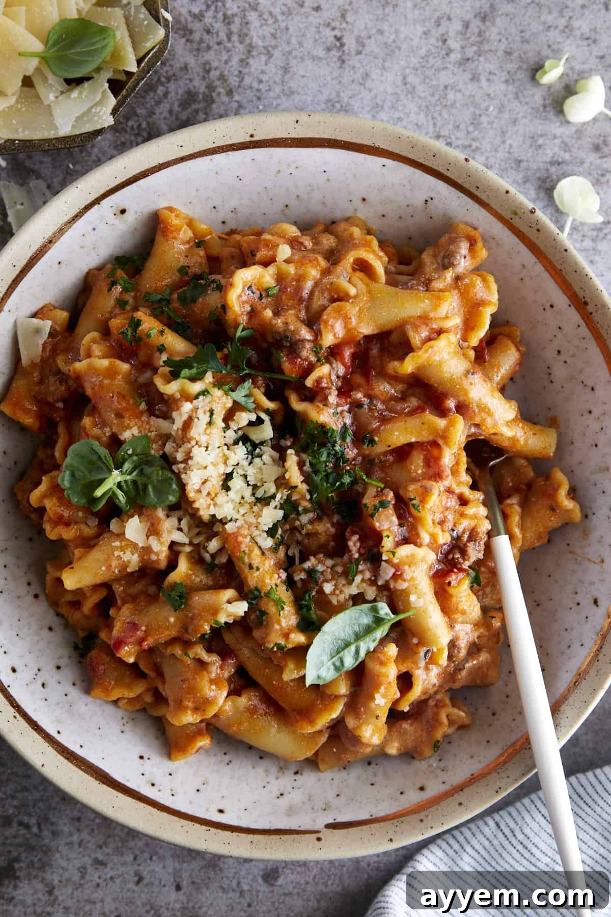 A bowl of one pot lasagna pasta topped with Parmesan cheese. 