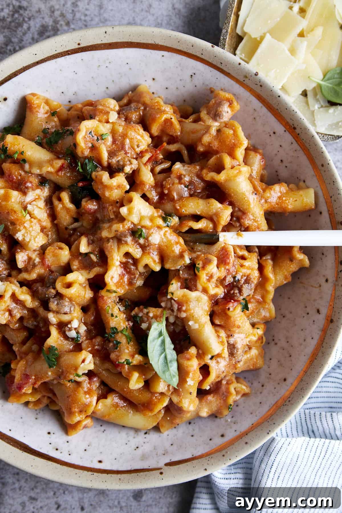 Overhead image of a bowl of one pot lasagna pasta with a spoon sticking out. 